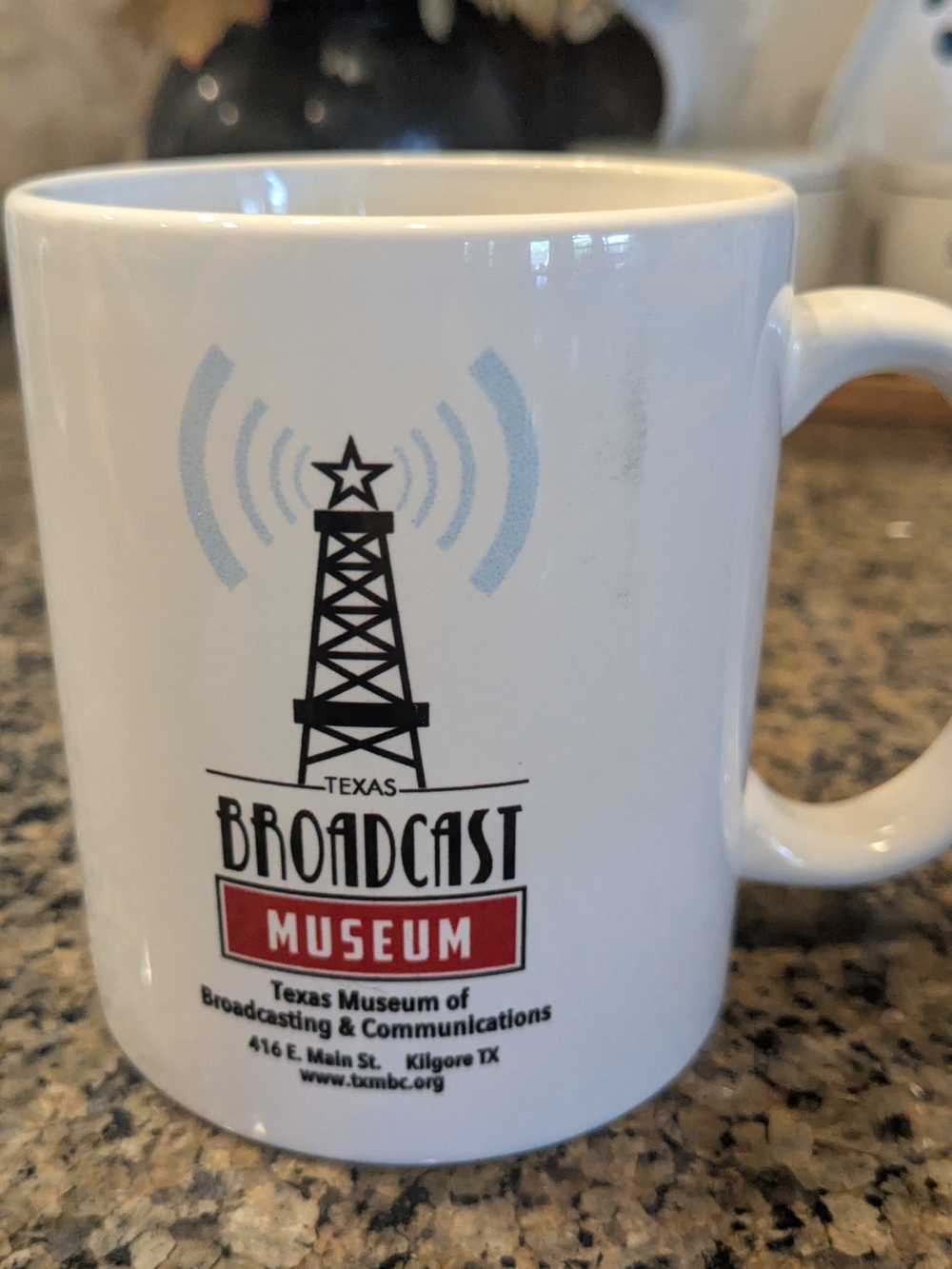 Source Unknown White Ceramic Mug with Black Logo and Red Accent